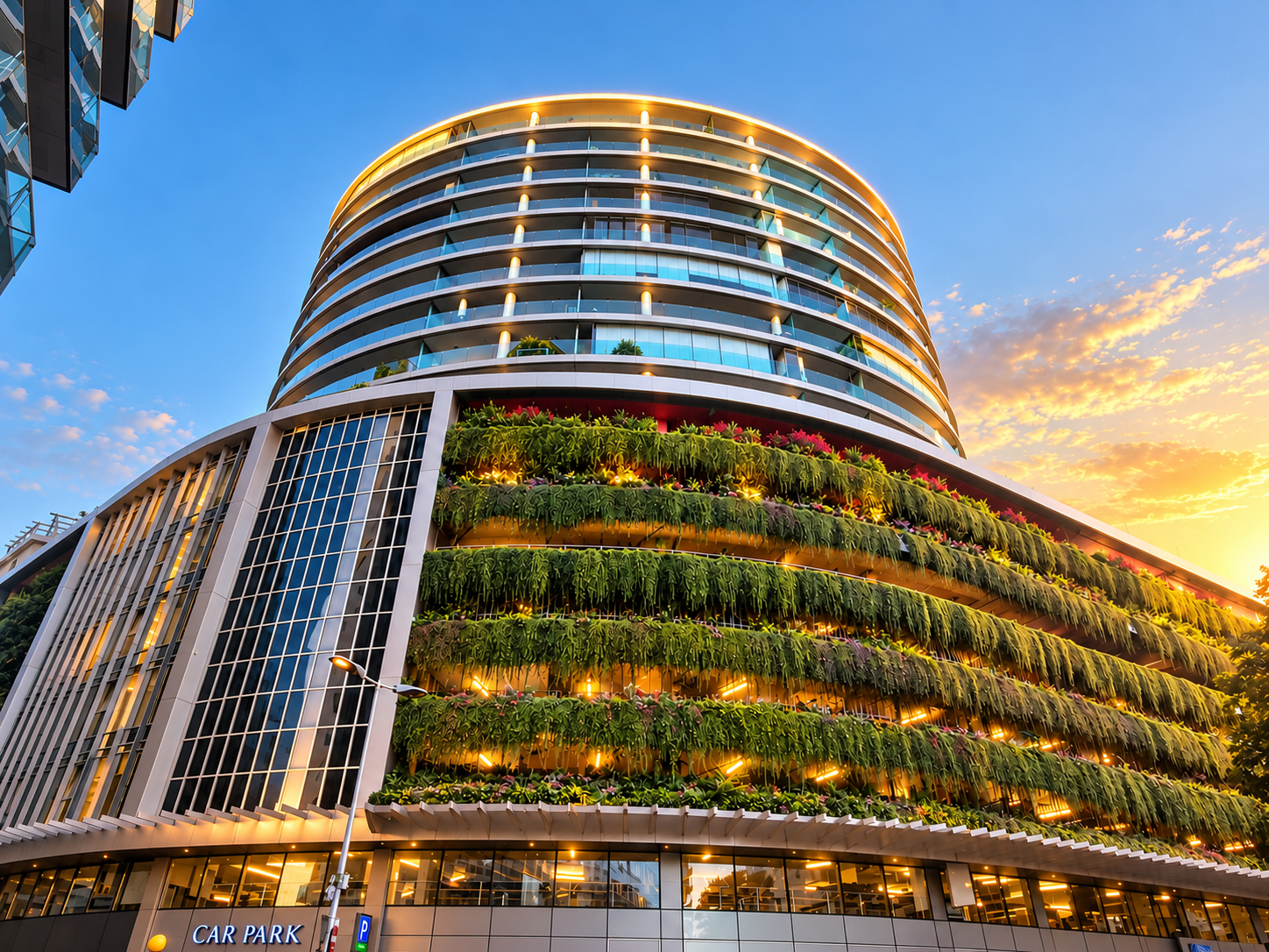 Ocean Spa Plaza tower and its planted podium terraces glowing at dusk above Ocean Village